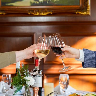 Hands clinking their glasses.