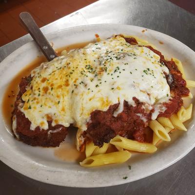 Chicken Parm, on a bed of penne pasta.