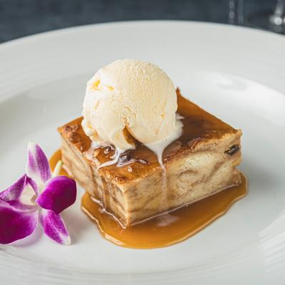 Bread pudding, topped with ice cream.
