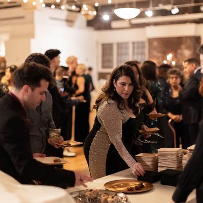 Interior, Guests helping themselves to buffet food.