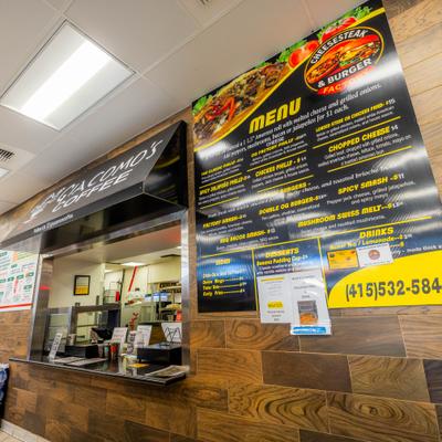 Restaurant counter with menu boards and ordering window.
