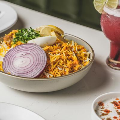 Chicken biryani, with rice and veggies.