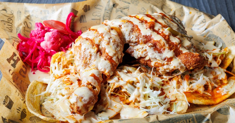 Fried chicken with banana, coleslaw, and dressings