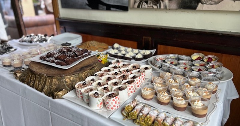A buffet table laden with various desserts