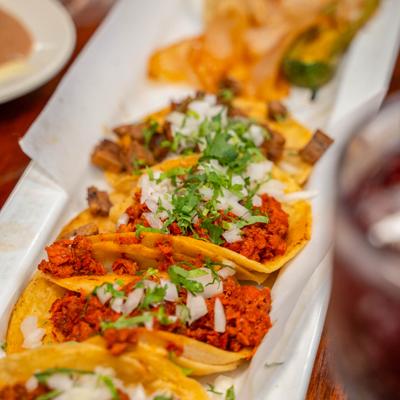 Marinated chicken tacos with onions and cilantro.