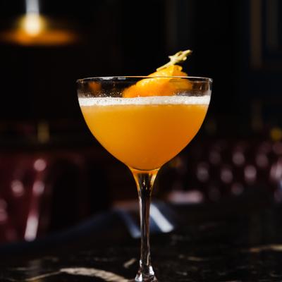 Orange cocktail, with an orange peel garnish