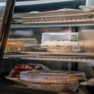 Packaged pies displayed on metal refrigerator shelves.