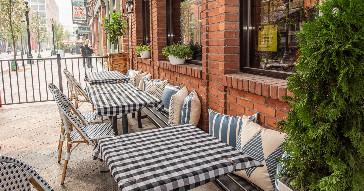 Outdoor café seating with black and white checkered tables