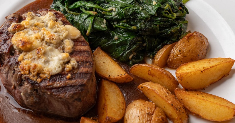 File mignon served with potato wedges and spinach