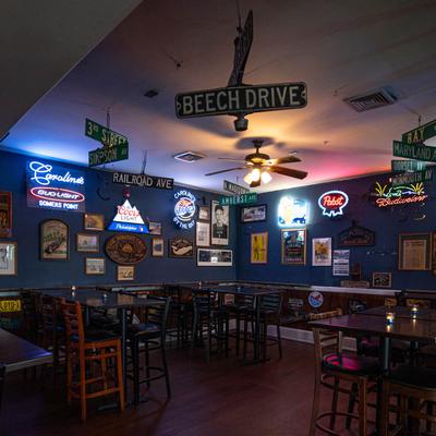 Tables with bar stools, space with decorated walls.