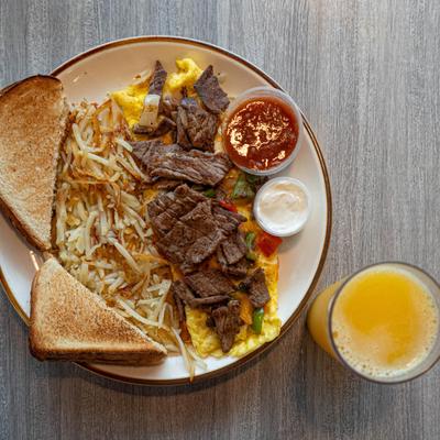 Steak Fajita Omelette with orange juice, top view.
