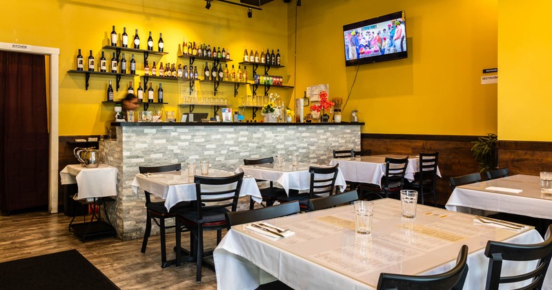 Interior, dining tables in front of the bar