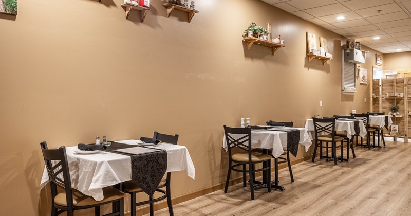 Interior, dining area with tables and chairs near wall