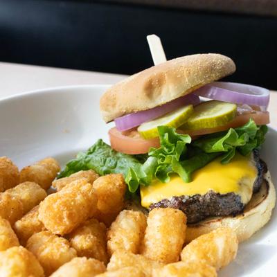 Cheeseburger with lettuce tomato pickles and tots.