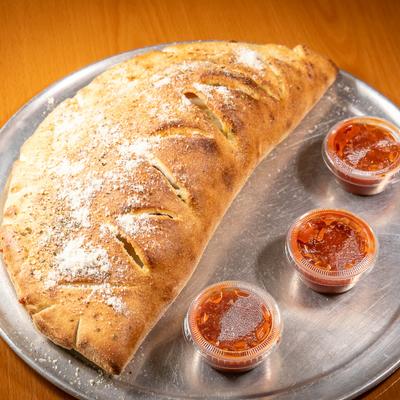Calzone, served with marinara sauce.