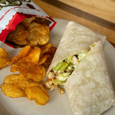 Chicken Caesar wrap served with crispy potato chips.