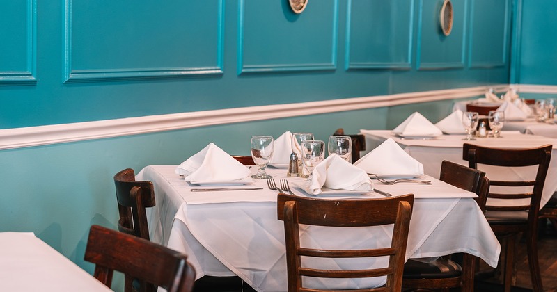 Dining tables with tableware ready for guests