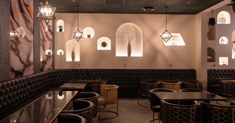 Interior featuring modern geometric pendant lighting and arched wall niches
