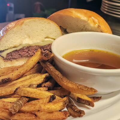 A served burger, fries, and dip.