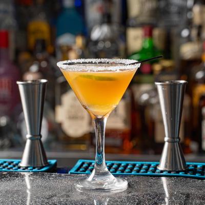 Classic Margarita served in a martini glass on a bar counter.