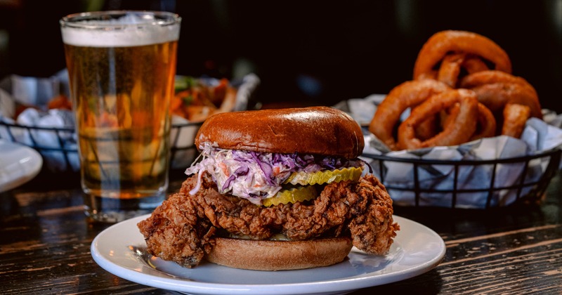 Fried chicken sandwich topped with red cabbage slaw