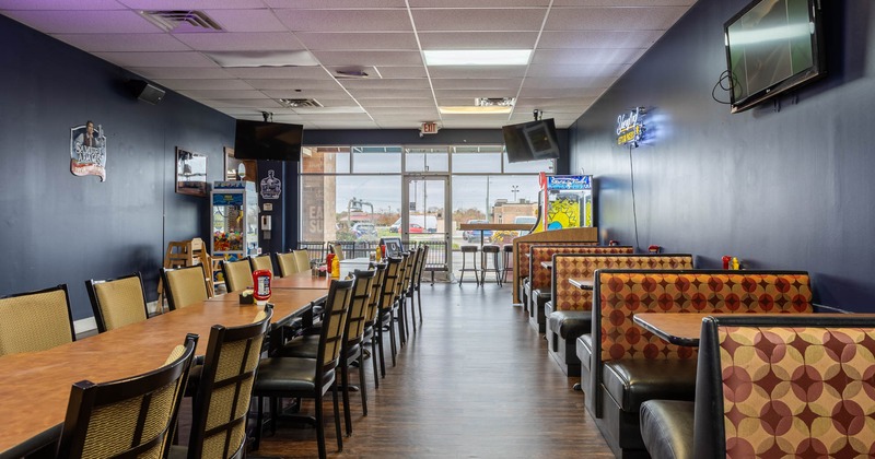 Interior, long dining tables on the left, booth area on the right