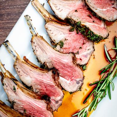 Petite Lamb Chops garnished with a spring of rosemary.