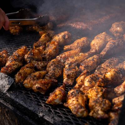 Wings cooking on a grill.