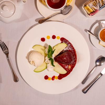 Poached pear with apple slices and vanilla ice cream.