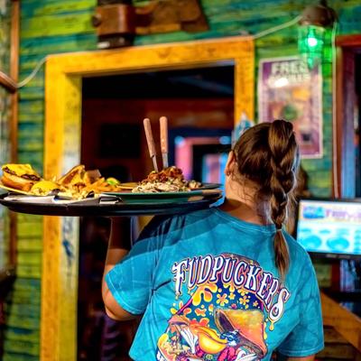 A server holding a tray with food on it.