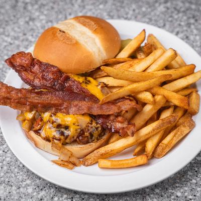 Cheeseburger topped with crispy bacon, served with fries.
