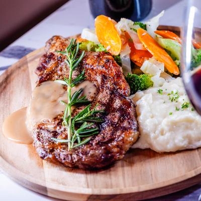 Grilled steak topped with creamy gravy and rosemary.