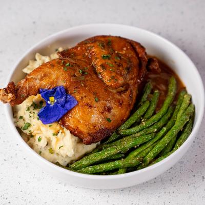 Roasted chicken paired with creamy mashed potatoes and green beans.