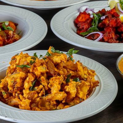Fried snack dish with herbs on plate.