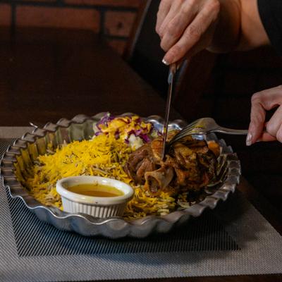 Cutting into lamb shank.