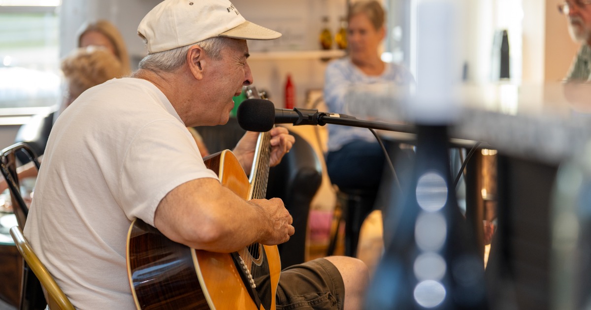 Guitarist, singer performing at a party