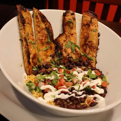 Grilled chicken, with salsa, rice, and beans.