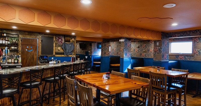 Interior, diner area, tables, chairs, bar with stools, booths behind