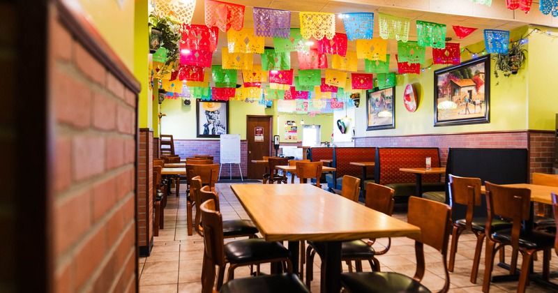 Interior, dining area, tables for six, four and two people, seating booths in the back