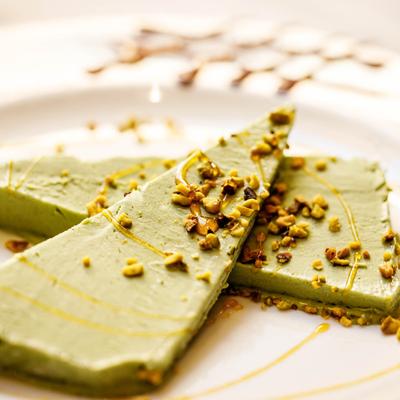 Homemade pistachio ice cream topped with crushed pistachios and drizzled with honey.