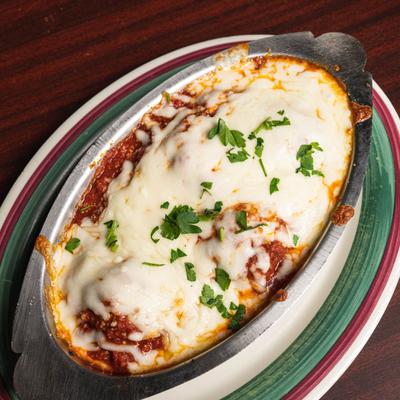 Meatballs with meat sauce, topped with melted mozzarella cheese