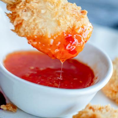 Coconut shrimp dipped in sweet chili sauce.