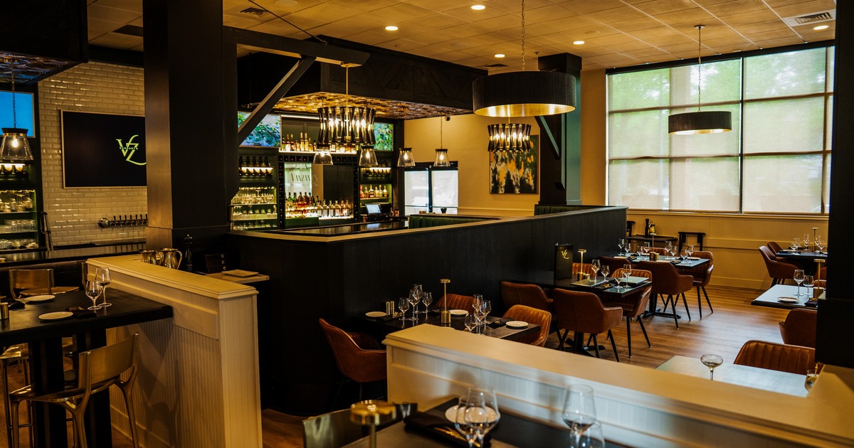 Interior, bar area and dining space with leather chairs
