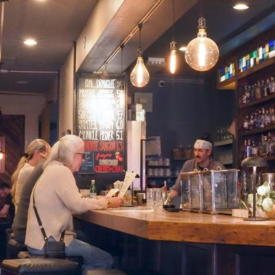 People seated at the restaurant bar counter.