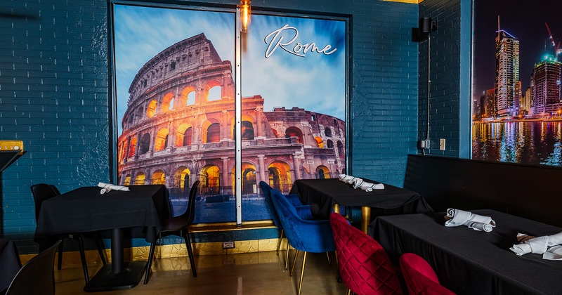 Restaurant interior, tables with black tablecloths and upholstered chairs in different colors