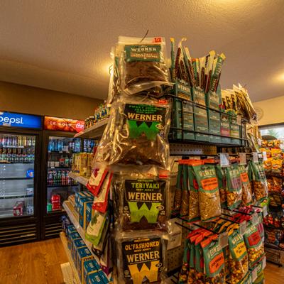 Interior featuring a display of various snack foods and branded refrigerated section.