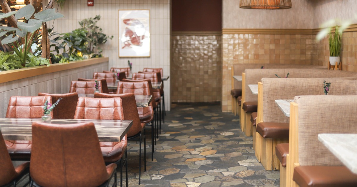 Interior, dining area, tables for four with leather chairs, seating booths on the right