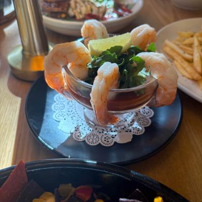 Shrimp cocktail with fries in the background.