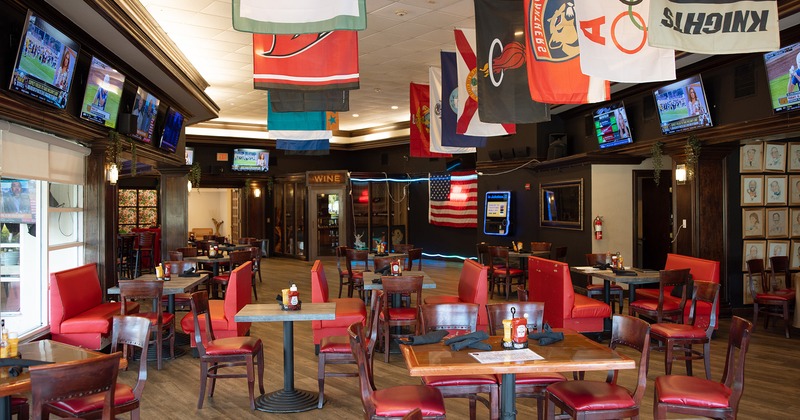 Interior, dining tables, TV sets, flags hang from the ceiling