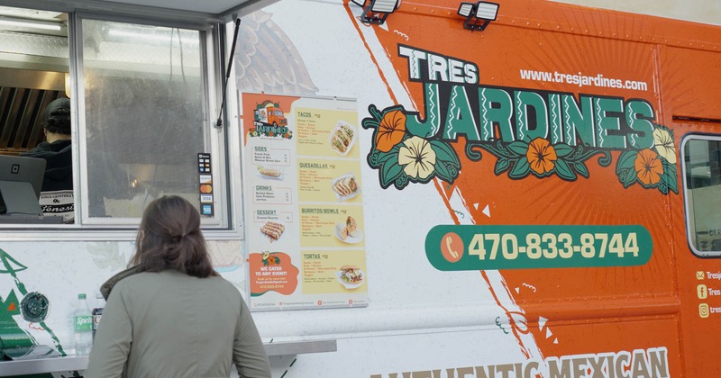 Customer waiting to be served in front of Tres Jardines food truck